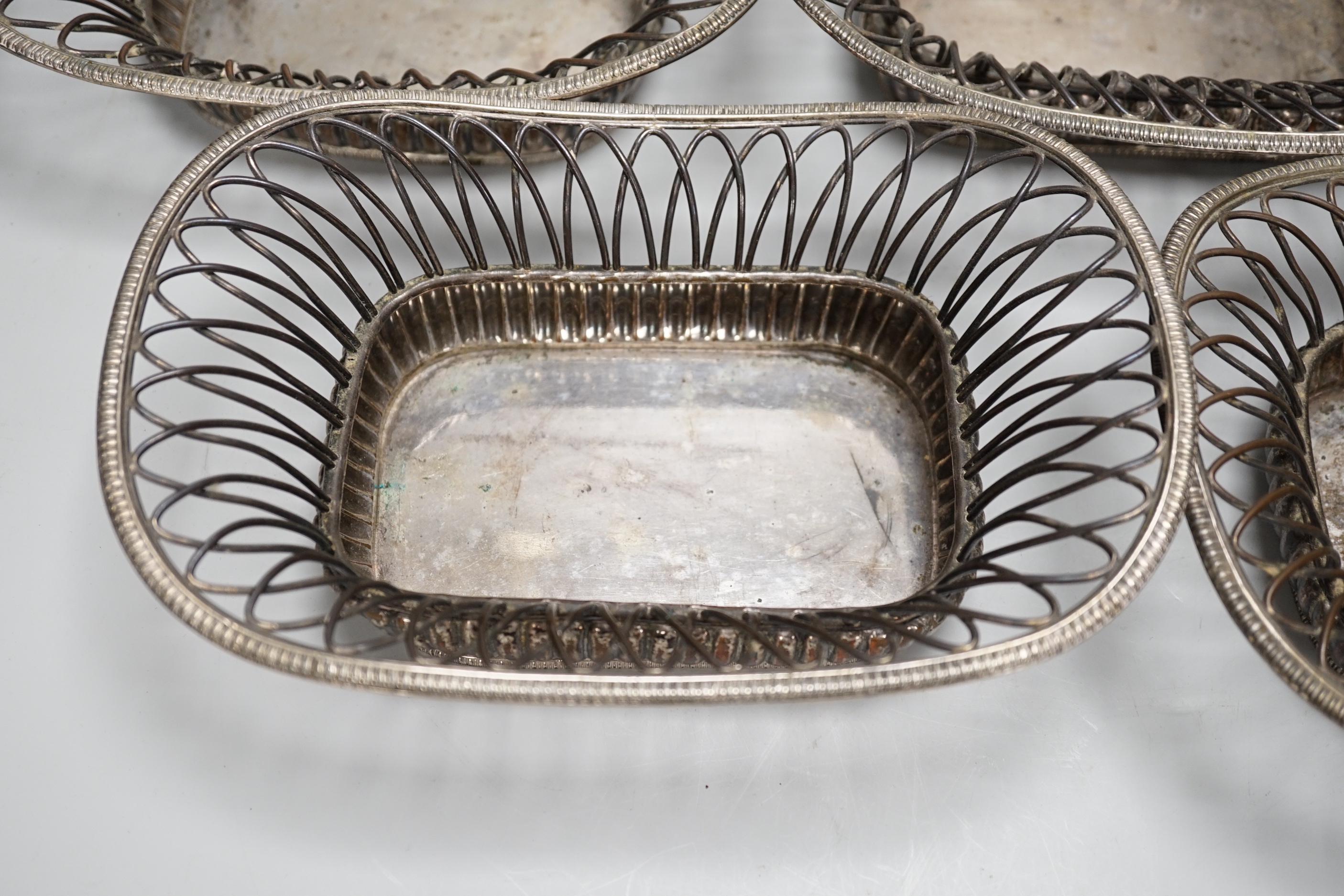 Four silver plated wire-work baskets, each 21cm wide